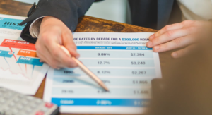 Finance professional reviewing rate sheets and invoices to evaluate vendor pricing with cost reduction consultants.