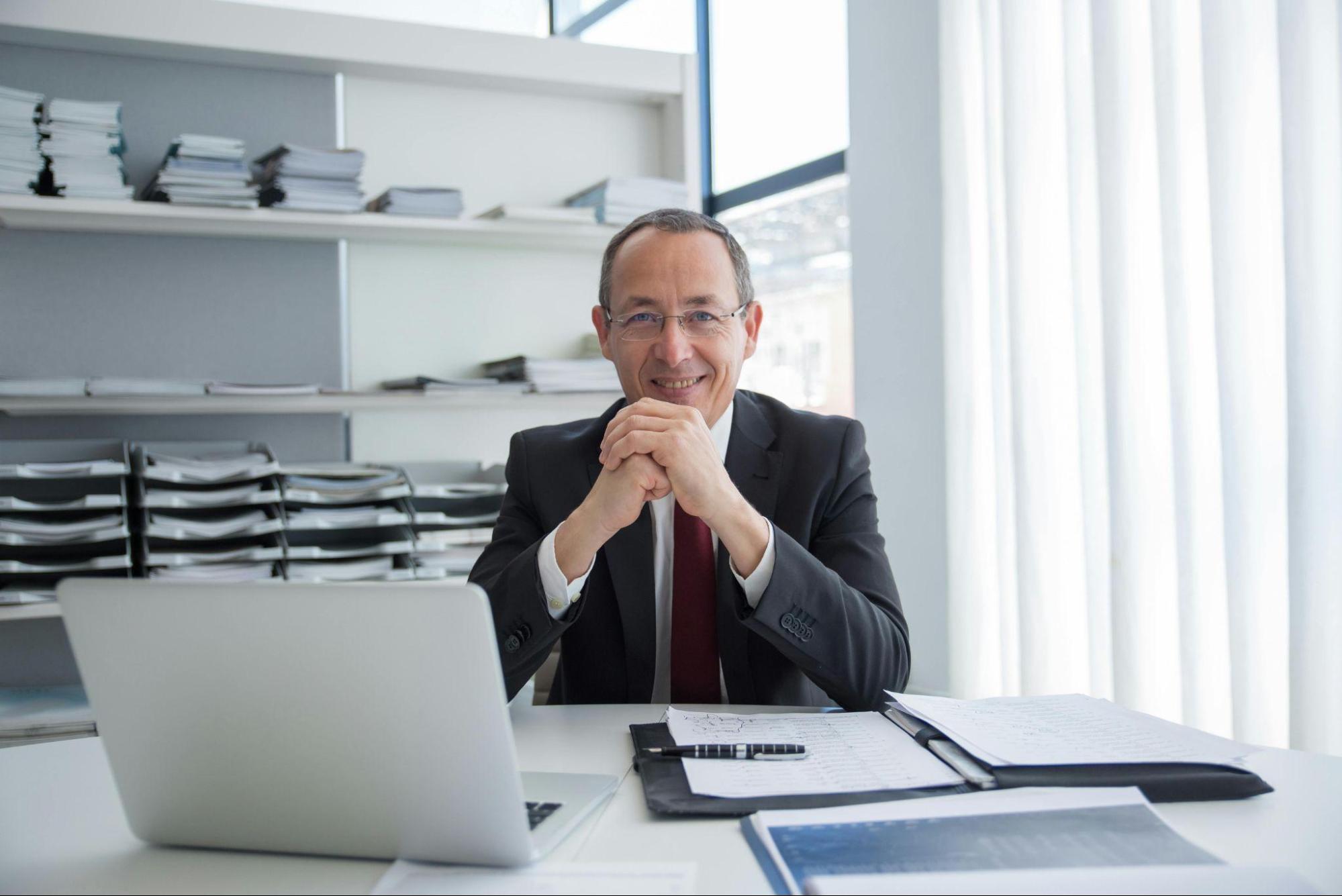 CFO reviewing invoices and financial reports to identify hidden cost inefficiencies and improve spend management with cost reduction consultants.