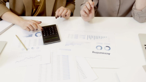 The finance team is analyzing invoices and cost data to identify savings opportunities and improve spend management with The SALT Group cost reduction consultants.