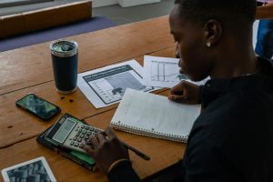 Finance professional reviewing invoices and calculations to identify vendor billing errors and improve accuracy in accounts payable approvals.