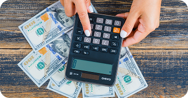 woman-counting-money-using-calculator 1