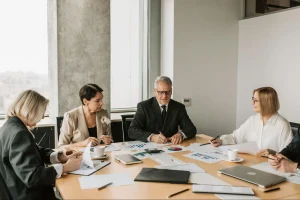 Business team reviewing documents and financial reports to improve spend management and support cost reduction consultants analysis