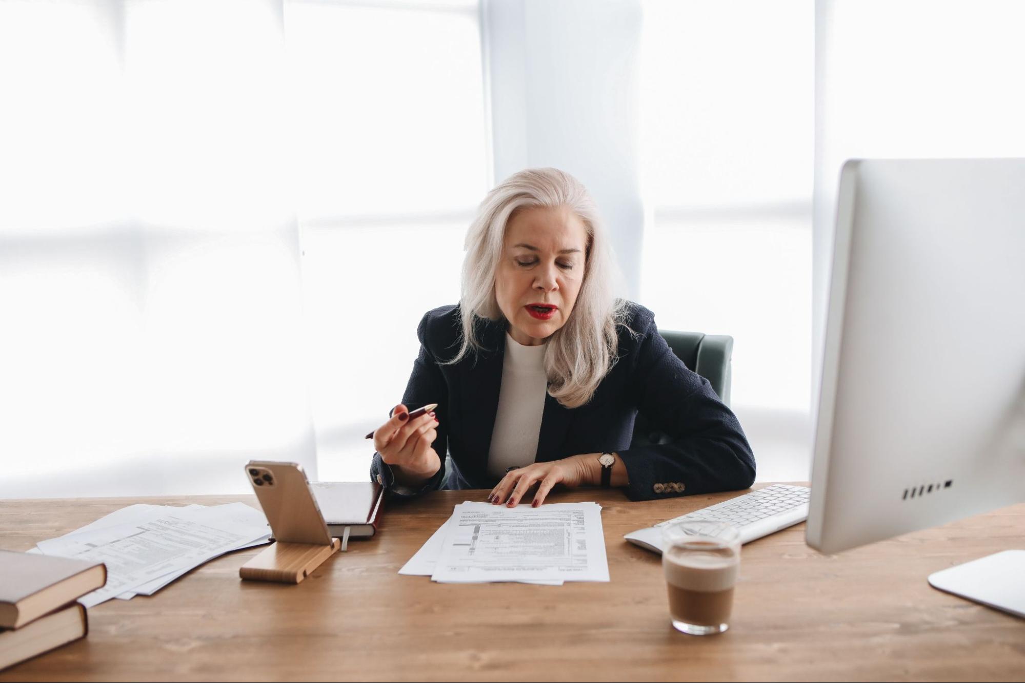 Finance professional reviewing ERP tax data and accounts payable invoices to improve spend management accuracy. 