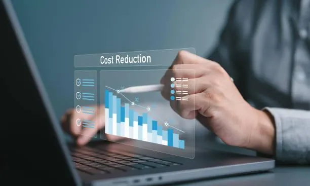 Business professional reviewing a digital cost reduction dashboard for manufacturing cost reduction.