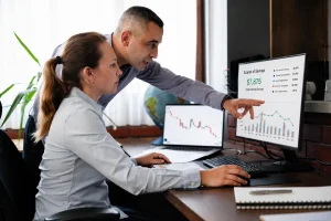 Professionals reviewing a savings dashboard and expense trends to monitor performance through ongoing spend controls and cost recovery.