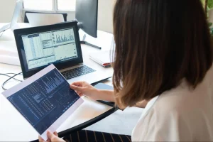 Manufacturing finance executive reviewing vendor contracts and benchmarks